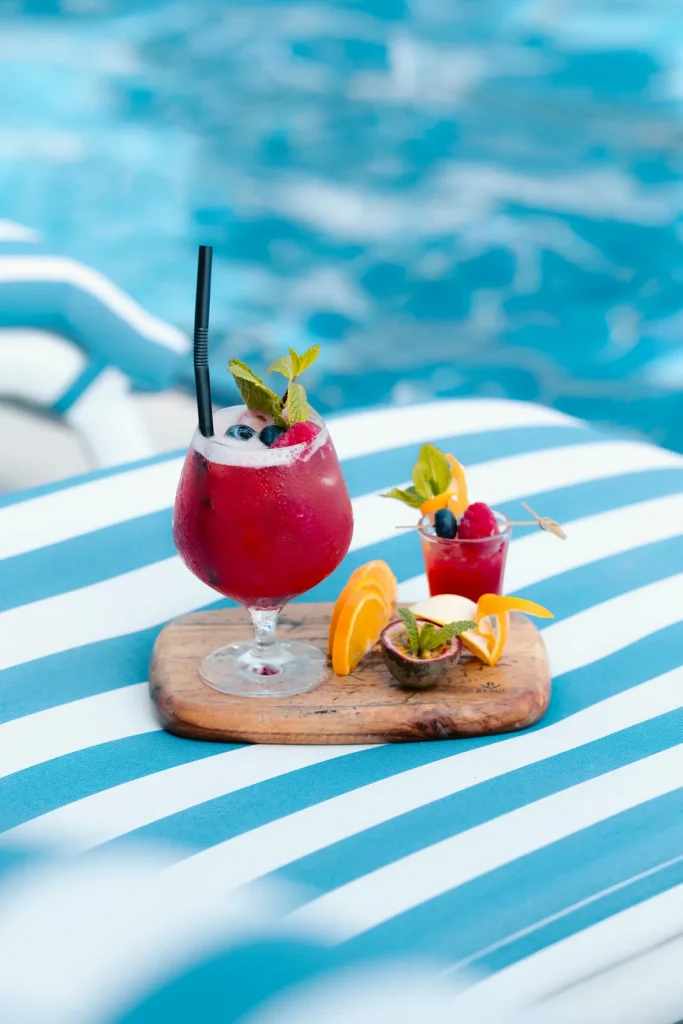 Red mocktail with fresh fruit on a pool lounger at Royal M Hotel Abu Dhabi