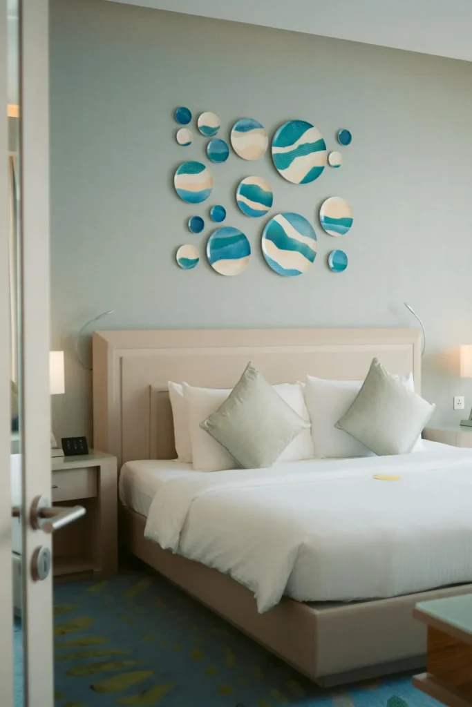 Bedroom with king bed and wall art at Royal M Hotel by Gewan Abu Dhabi